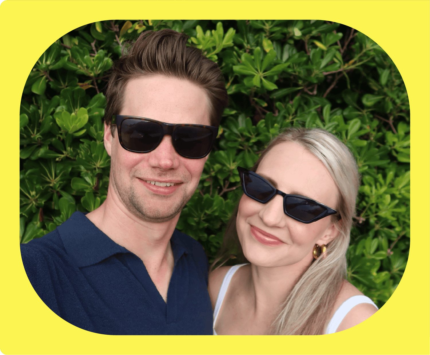 A picture of Oomfs founds Dylan and Lexi, both wearing sunglasses and smiling at the camera.