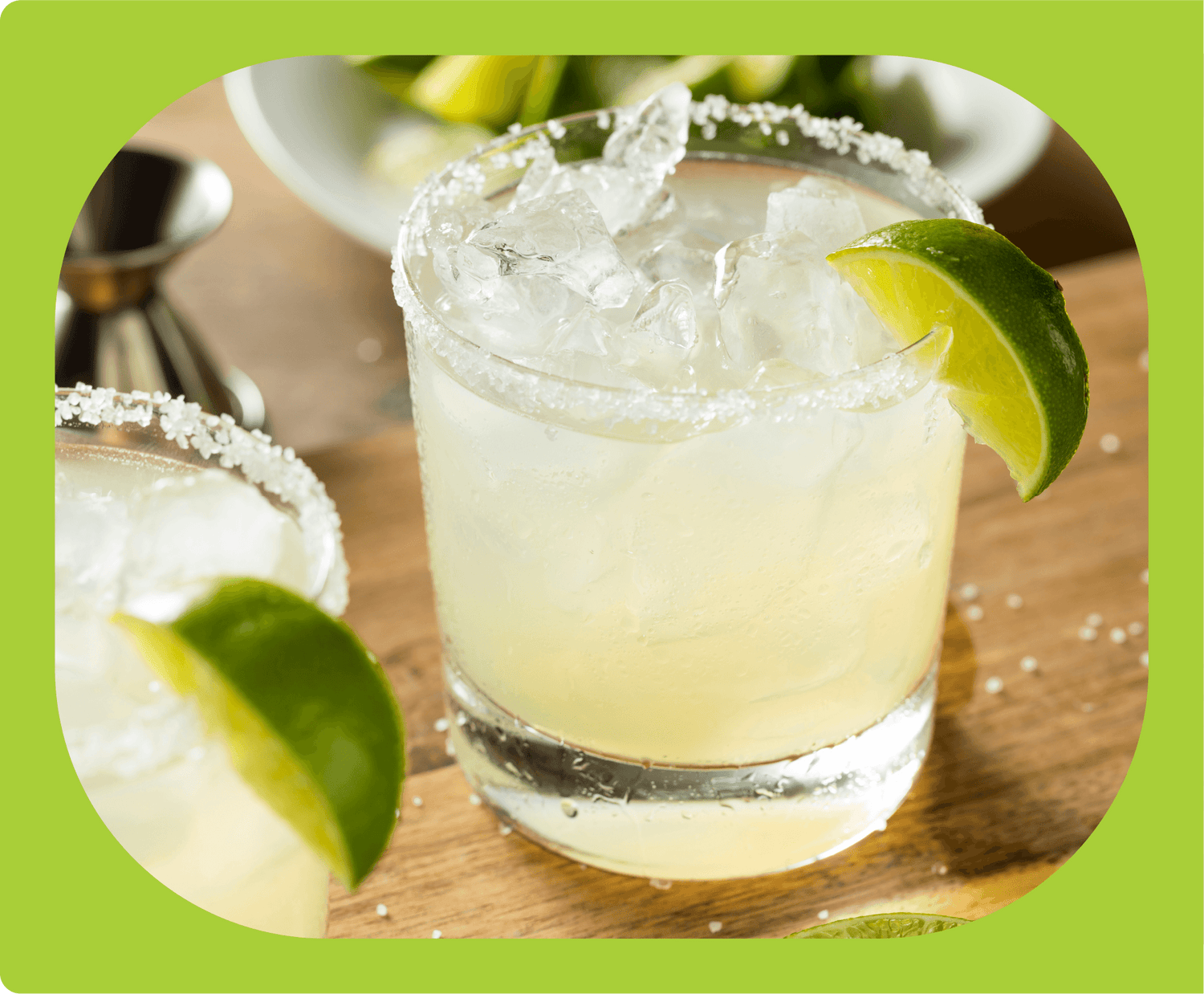 A margarita in a rocks glass, with a lime wedge and salt rim.